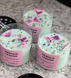 three candles with pink and blue decorations on them