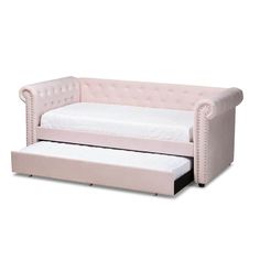 a pink couch with a white mattress underneath it