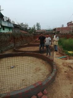 three men standing in front of a wire fence with the words bhandari gaun uttar shv mumbai parvel road