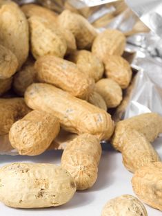 peanuts sitting on top of aluminum foil next to each other