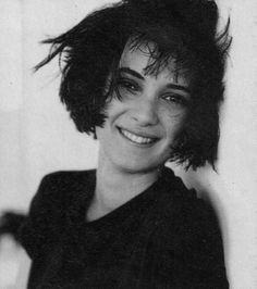 a black and white photo of a woman with short hair