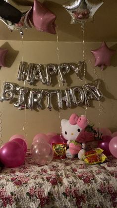 a hello kitty birthday party with balloons and streamers