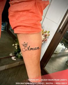 a woman with a tattoo on her arm that reads aman and has a crown