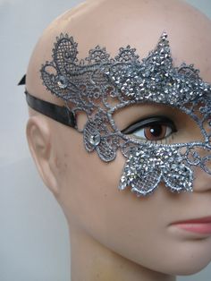 * This stiff silver lace half mask has been designed with five pointed silver beaded stars which have been trimmed and stationed around each eye. Down the front of the mask four faceted crystals accent the shape of the nose. * To secure the mask there are two black satin ribbons on each side to be tied in the back. * A great piece for a Masked Ball, a Night at the Opera, Class Reunion, Birthday Celebration, Halloween, New Year's Celebrations, Parade or Festival, Costume party or Play, Carnivale, Silver Full Face Mask For Masquerade, Silver Full Face Masquerade Mask, Full Face Silver Masquerade Mask, Silver Gothic Mask For Costume Party, Silver Gothic Eye Mask For Masquerade, Gothic Silver Mask For Costume Party, Silver Gothic Eye Masquerade Mask, Gothic Silver Eye Masquerade Mask, Silver Rhinestone Eye Mask For Masquerade