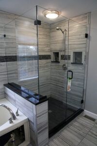 a bathroom with a walk in shower next to a bathtub