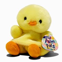 a small yellow stuffed animal sitting next to a tag on a white background with the word palm pals printed on it