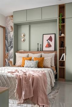 a bedroom with a bed, bookshelf and pictures on the wall above it