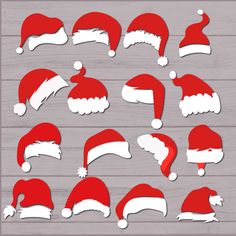 red and white santa claus hats cut out on wood planks for christmas decorating