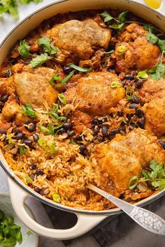 chicken and rice dish with garnishes in a pan