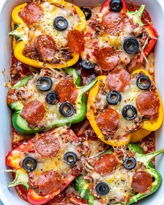 a casserole dish filled with pepperoni, peppers and cheese topped with olives