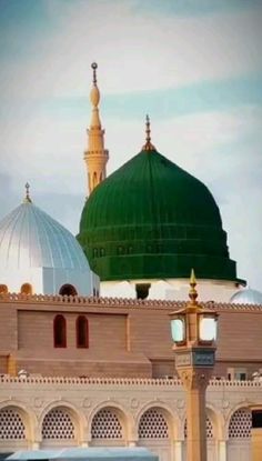 two green and white domes on top of a building