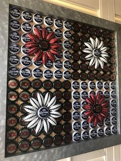 an art piece made out of beer bottle caps with red and white flowers on them