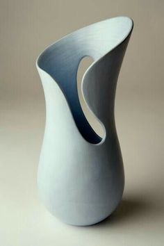 a white and blue vase sitting on top of a table