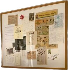 a bulletin board covered in papers and pictures