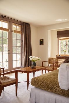 a living room filled with furniture and lots of windows