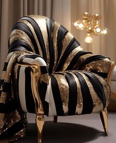 a black and white chair with gold stripes on it's back, next to a chandelier