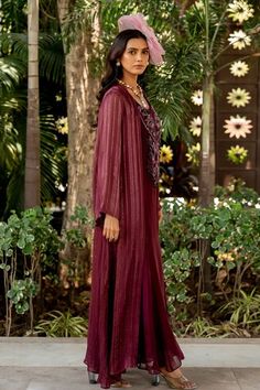 Wine dress with thread, beads, nakshi and tassels embroidery. Comes with a cape and an inner. - Aza Fashions Bohemian Dresses With Cape Sleeves For Festive Occasions, Festive Bohemian Dress With Cape Sleeves, Festive Kaftan With Sheer Dupatta And Cape Sleeves, Festive Sheer Dupatta Kaftan With Cape Sleeves, Festive Embroidered Kaftan With Cape Sleeves, Traditional Eid Dresses With Cape Sleeves, Designer Eid Dresses With Tassels, Eid Designer Dresses With Tassels, Eid Dresses With Tassels