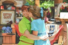 two children hugging each other in front of a booth