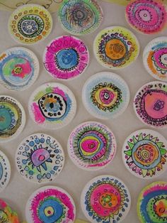 a bunch of paper plates that have different designs on them