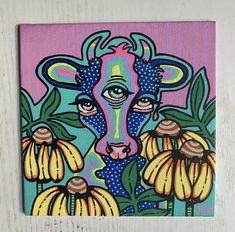 a painting of a cow surrounded by flowers