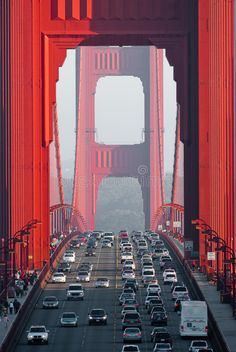 cars are driving over the golden gate bridge