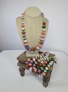 a necklace is sitting on top of a wooden stand