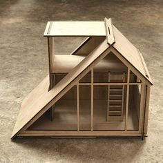 a wooden model of a house on the ground