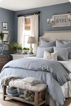 a bed sitting in a bedroom next to a window covered in blue and white sheets