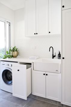 a washer and dryer in a white kitchen