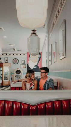 a man and woman sitting at a table in a restaurant