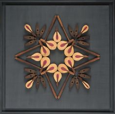 an intricately designed piece of wood in the shape of a snowflake on a gray background