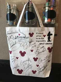 a tote bag with writing on it and mickey mouse's handwritten notes