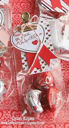 valentine's day treat bags with hersheys in them on a red and white tablecloth