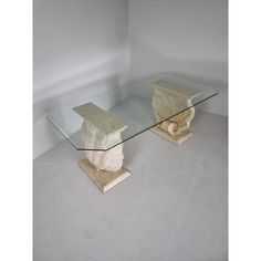 a glass and stone table in the middle of a room