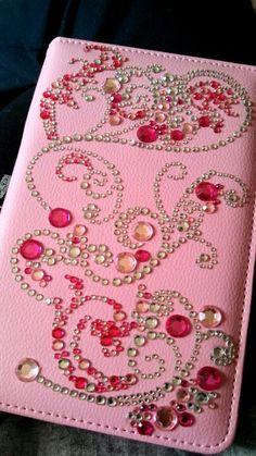 a pink case with lots of jewels on it