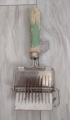 a metal grater sitting on top of a wooden floor next to a tile floor