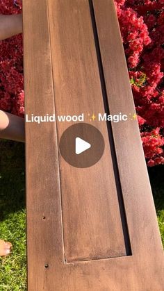 someone is holding a piece of wood in their hand with the words liquid wood and magic written on it