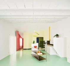 an empty room with white walls and green flooring is seen in this image, it appears to be very colorful