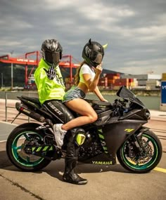 a man and woman sitting on a motorcycle