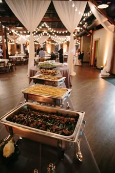 several trays filled with food sitting on top of a table