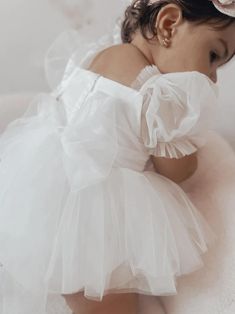 Offering a stunning design and comfortable fit, the Goddess Puff Sleeve Baby Dress features multiple layers of soft, lightweight mesh. This dress boasts a delicate lace tutu skirt and puff sleeves for a princess-inspired look. Perfect for photoshoots, special occasions, and even weddings, this dress is available in sizes 3-24 months and features a beautiful bow tie at the back. Material: Cotton, Viscose, Lace Includes: Dress only Specifications: Garment Type: DressAge Group: Newborn/Infant/Toddl White Baby Dress, Girls Tulle Dress, Princess Inspired, Stretch Headband, Flower Fairy, Cotton Viscose, Tulle Fabric