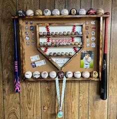 a baseball themed display on a wooden wall with various items hanging from it's sides