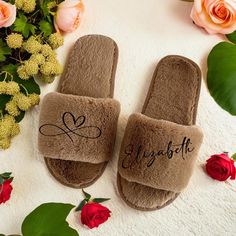 two personalized slippers with the word love on them next to flowers and greenery