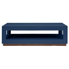 a blue coffee table sitting on top of a white floor next to a wooden shelf