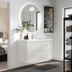 a bathroom with a sink, mirror and shelves on the wall next to each other