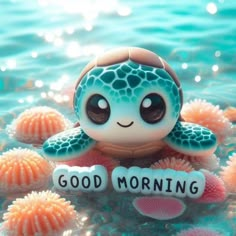 a small turtle with the words good morning on it's chest sitting in some corals