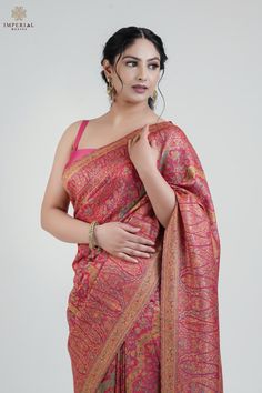 The Pink Kani Jamawar Khatras Silk Saree is a stunning embodiment of traditional craftsmanship, crafted from premium silk fabric. This saree features intricate Kani Jamawar weaving with delicate floral and diagonal patterns across the body, complemented by elegant paisley motifs on the borders and pallu. The beautiful pink hue is enriched by subtle touches of zari thread, adding a regal charm to the saree. It is elegantly paired with a matching blouse piece that showcases scattered Kani weaving in a graceful booti pattern. Inspired by the heritage weaves of ancient Pashmina shawls from the Mughal era, this saree celebrates the rich legacy of Kani weaving--a craft that has been cherished and refined over millennia. Kani, an ancient art form from Kashmir, has been passed down through generat Pashmina Saree, Pashmina Silk, Paisley Motifs, New Saree Blouse Designs, Pink Crafts, Latest Sarees, Festive Wear, Pashmina Shawl, Saree Look