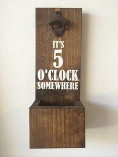 a wooden block with the words it's 5 o'clock somewhere on it