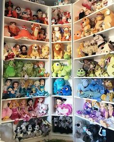 the shelves are filled with many different disney stuffed animals and other plush animal toys in them