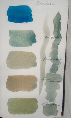 several different shades of blue and green ink on white paper with writing in the middle